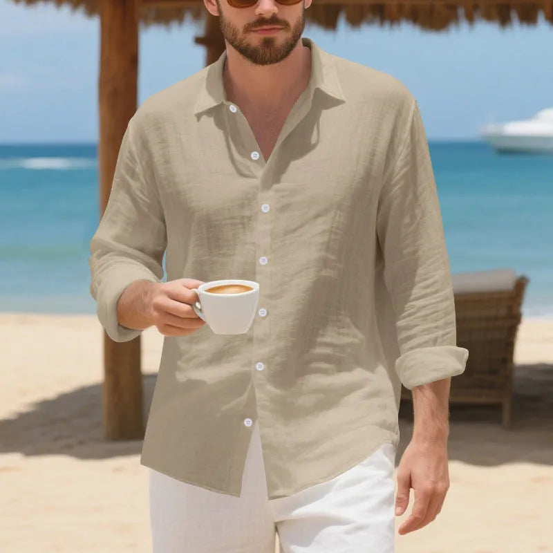 A man wearing a loose-fit light blue linen casual shirt with a non-iron finish, buttoned front and standard collar.