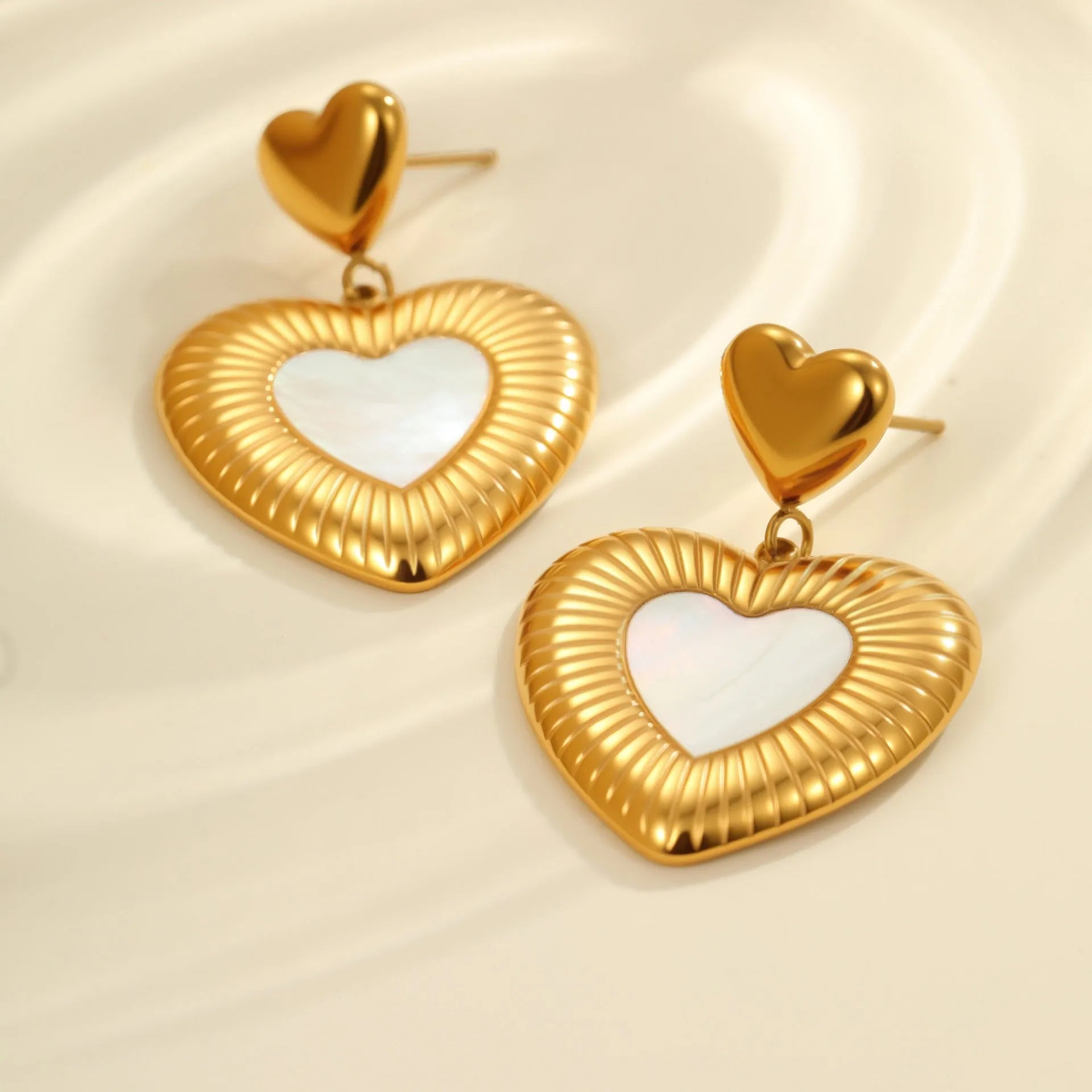 Gold-colour electroplated heart earrings with fritillary detail on stainless steel