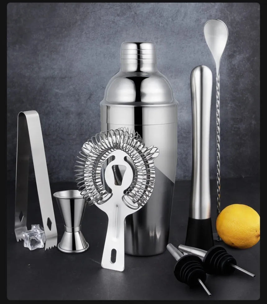 23-piece stainless steel cocktail set with acrylic shakers and bar tools laid out.
