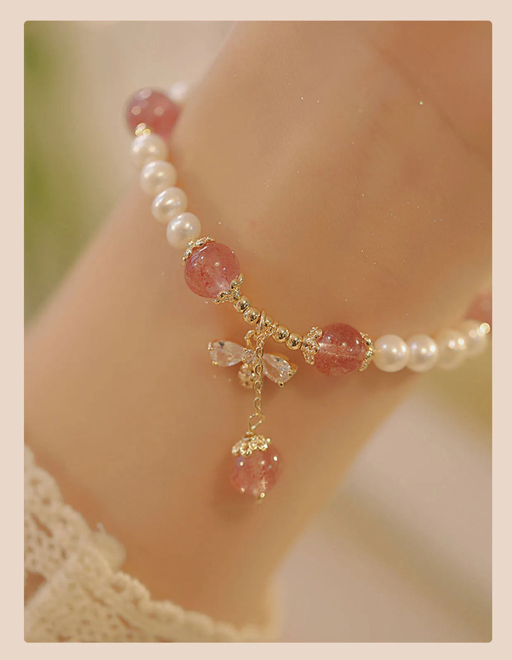 Handmade women's strawberry quartz crystal bracelet with a decorative bow clasp.