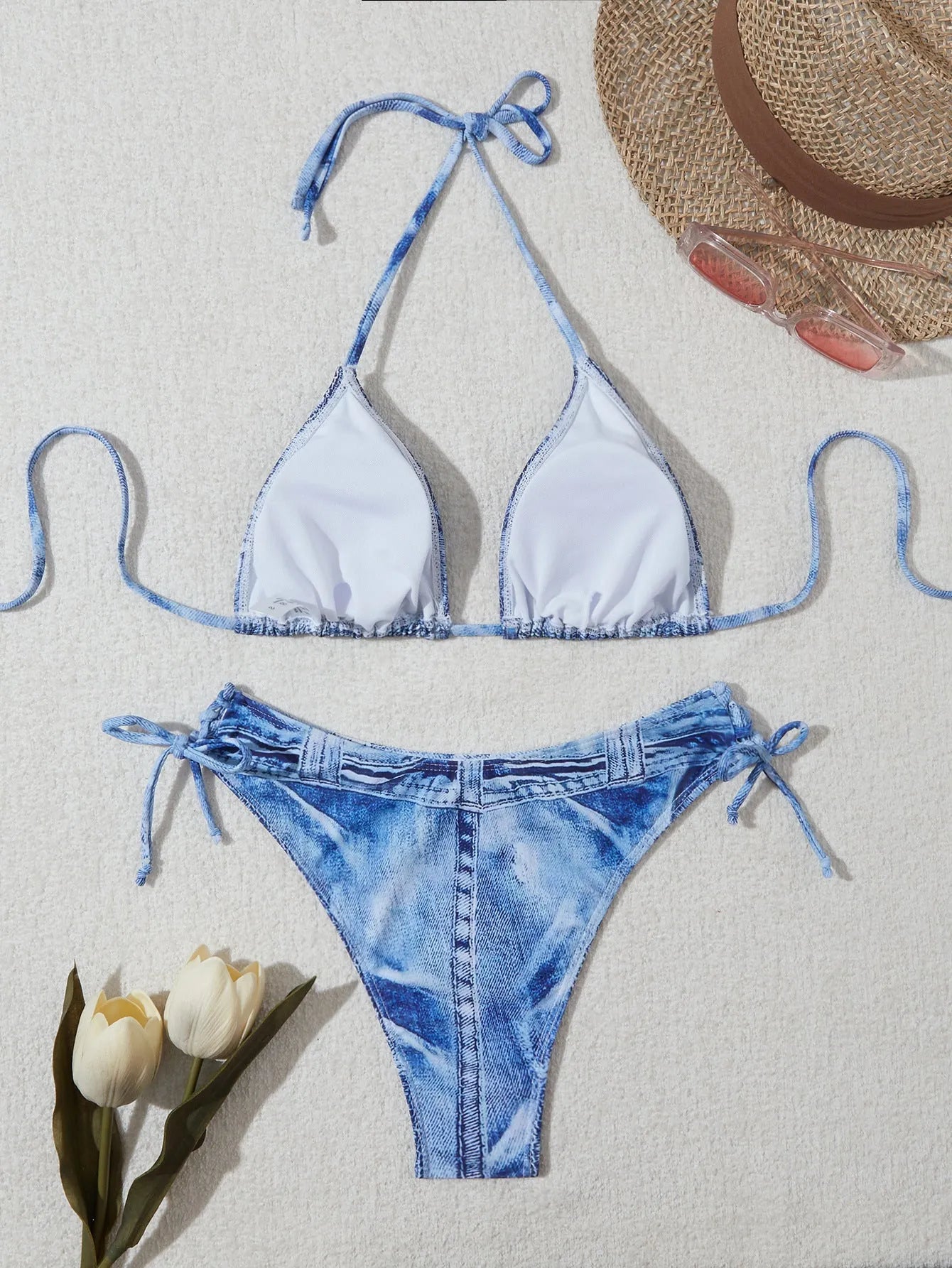 Denim blue printed women's bikini set with strap detailing on a white background.
