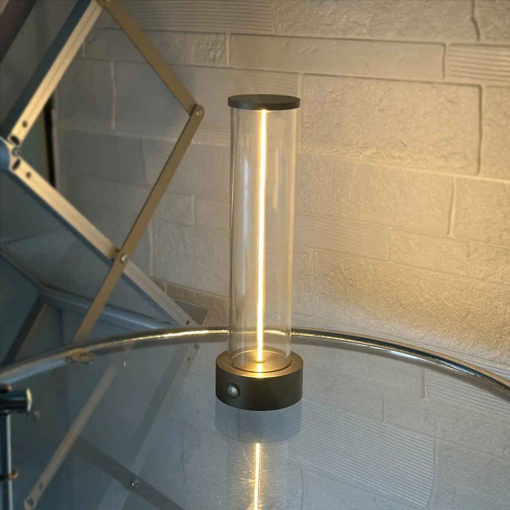 Slim modern glass LED bar night light with magnetic base on a desk surface.
