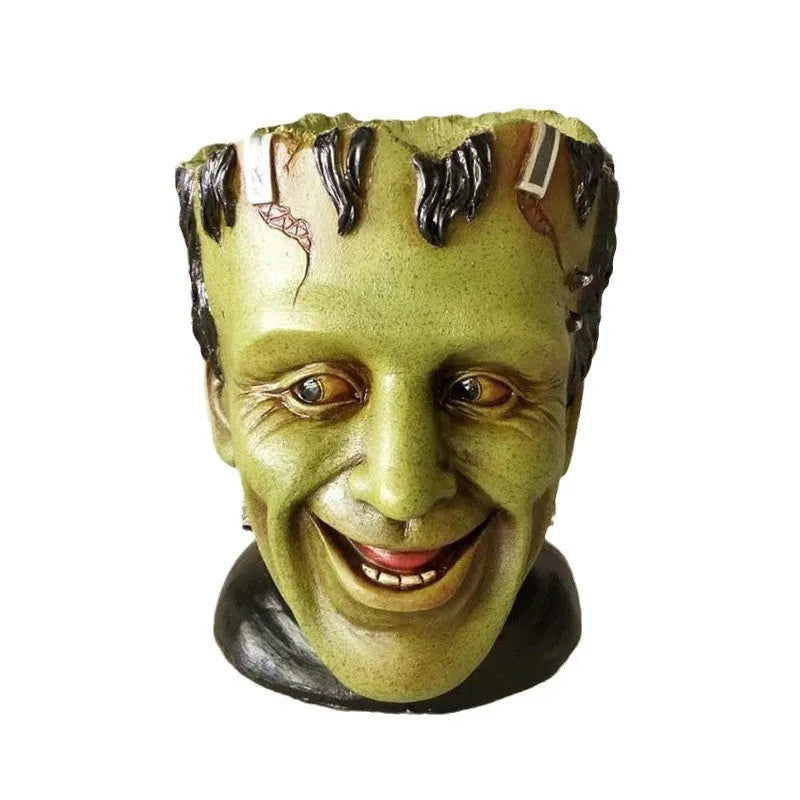 Green personalized resin flower pot with Frankenstein container design and drainage holes for desktop plant display