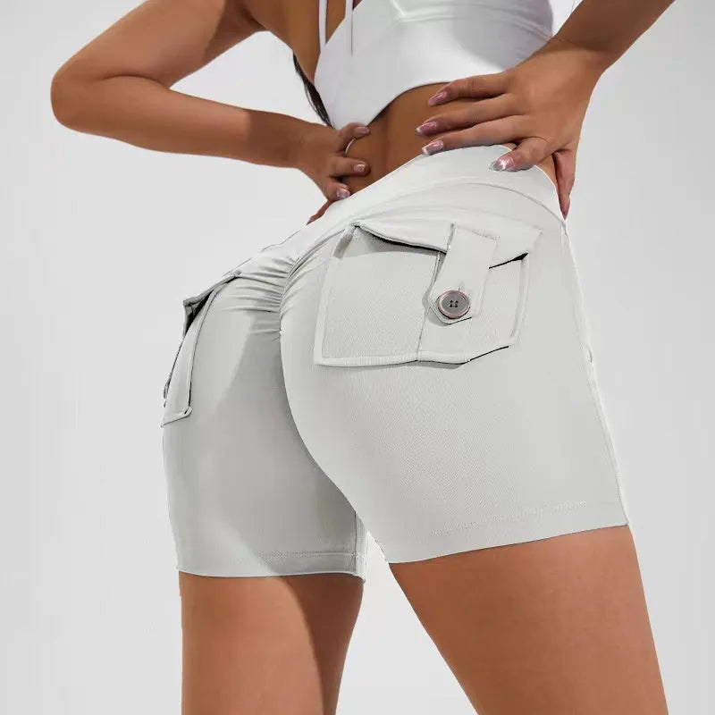 Women's high waist nylon fitness shorts in avocado green with side pockets, laid flat.