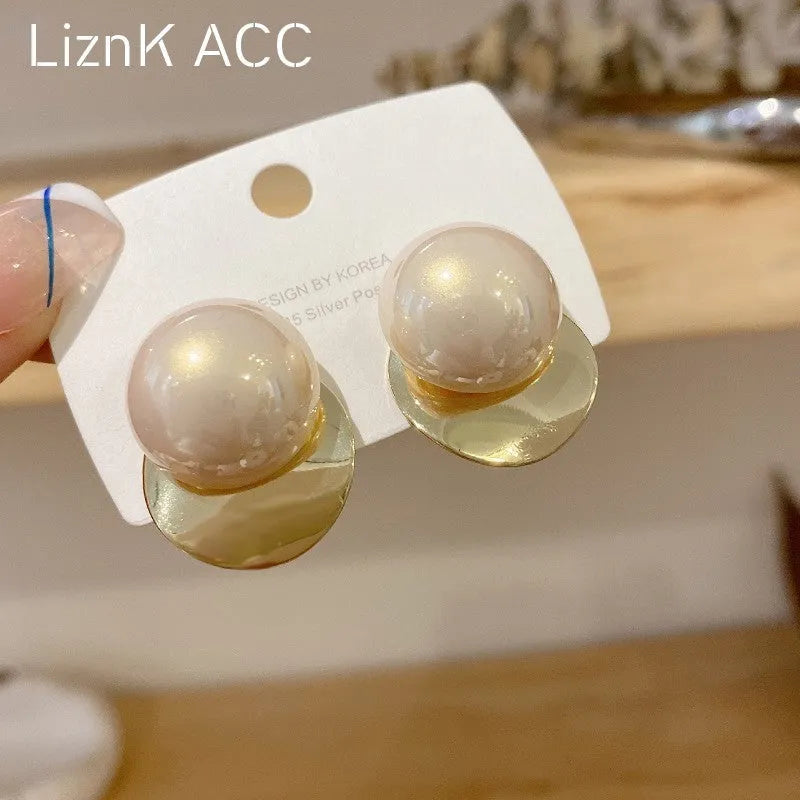 Fashionable alloy round drop earrings in gold tone, 1.2 cm diameter, on a white background