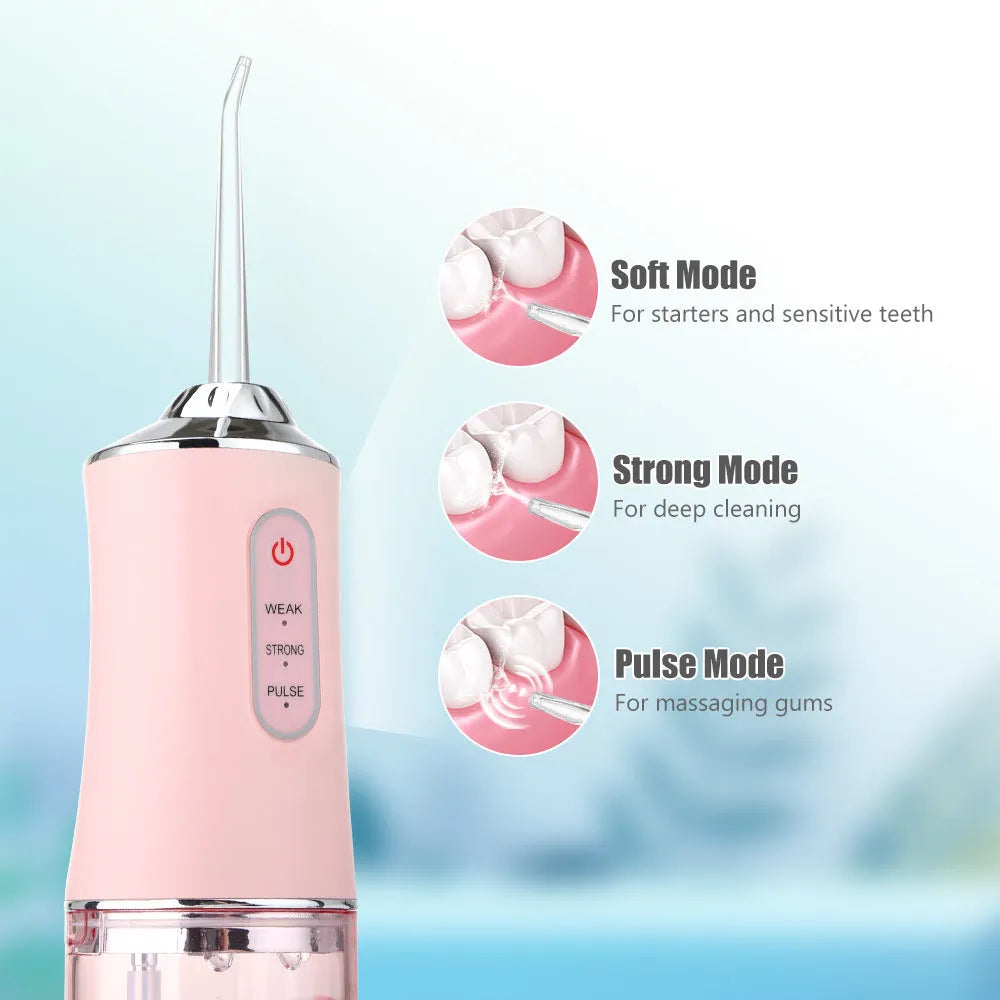 Handheld electric water pick in white, pink or light green with three speed settings, under 300mL tank, USB cable and four nozzles