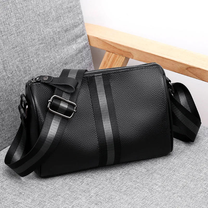 Black genuine leather one-shoulder crossbody bag showing its large capacity and strap.