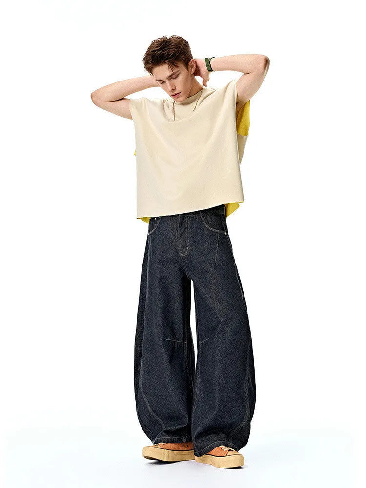Men's original cow colour wide leg denim trousers laid flat.