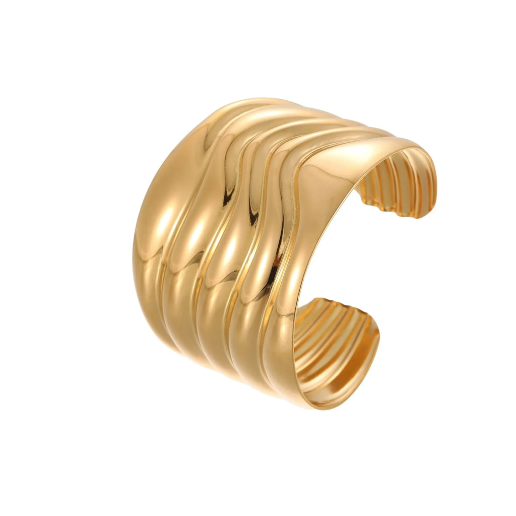 Women's wide stainless steel bracelet with 18K gold plating in a wave and geometric design.