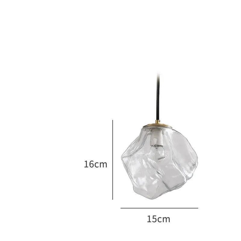 Minimalist ice cube glass chandelier with warm 4000K light, smoky grey shade and black hanging wire over a dining table