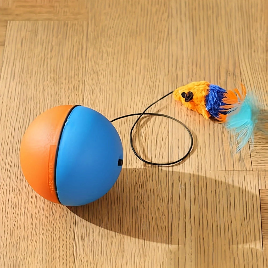 Interactive blue and orange cat toy ball with plush mouse attachment, shown next to a ruler for scale.