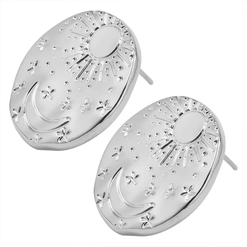 A pair of geometric stainless steel earring studs with a shell detail, shown in gold and silver colours.
