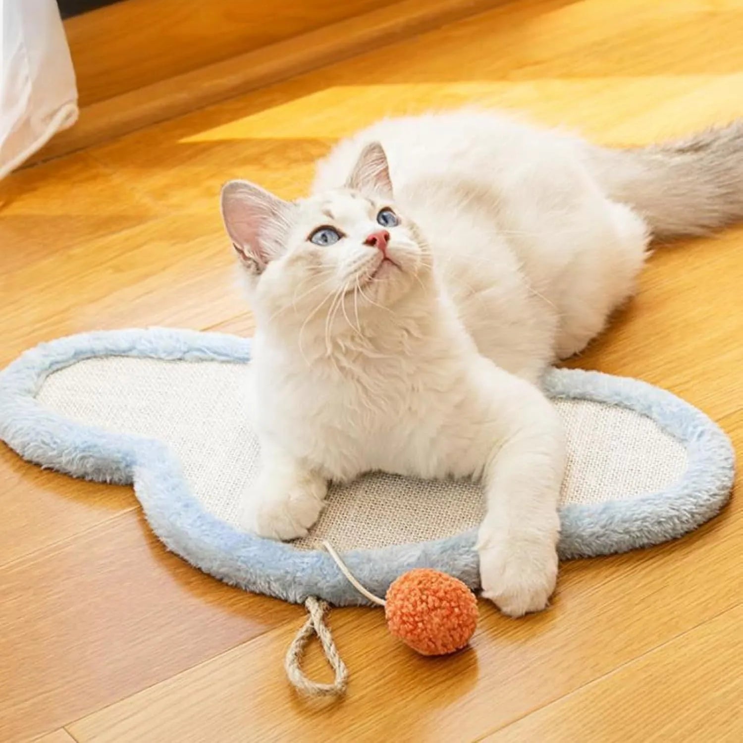 White cat scratching mat with cartoon sleeping cat design made from natural sisal fibre.