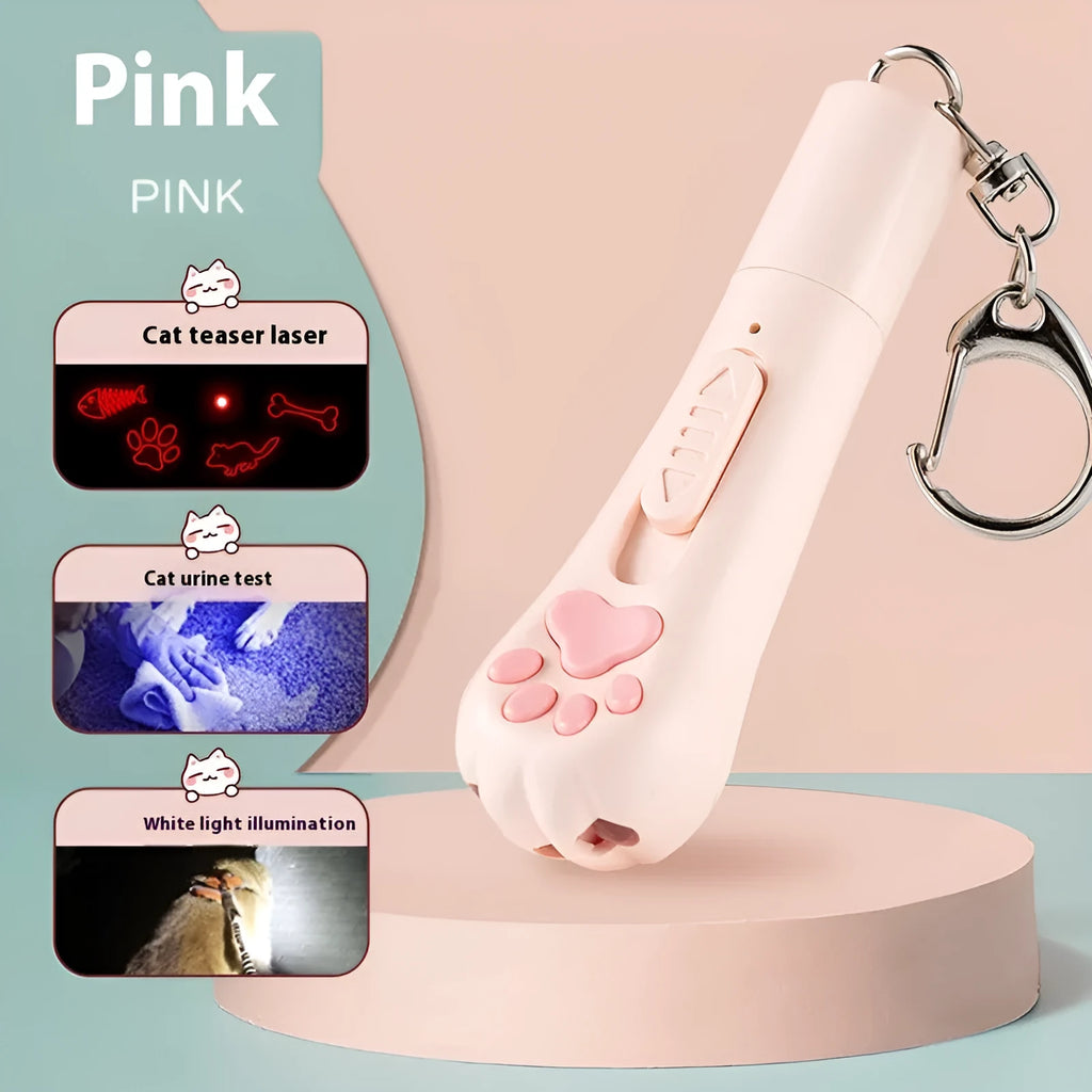 Pink automatic cat teaser toy with a wand attachment on a hardwood floor, showing compact circular base.