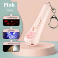 Pink automatic cat teaser toy with a wand attachment on a hardwood floor, showing compact circular base.