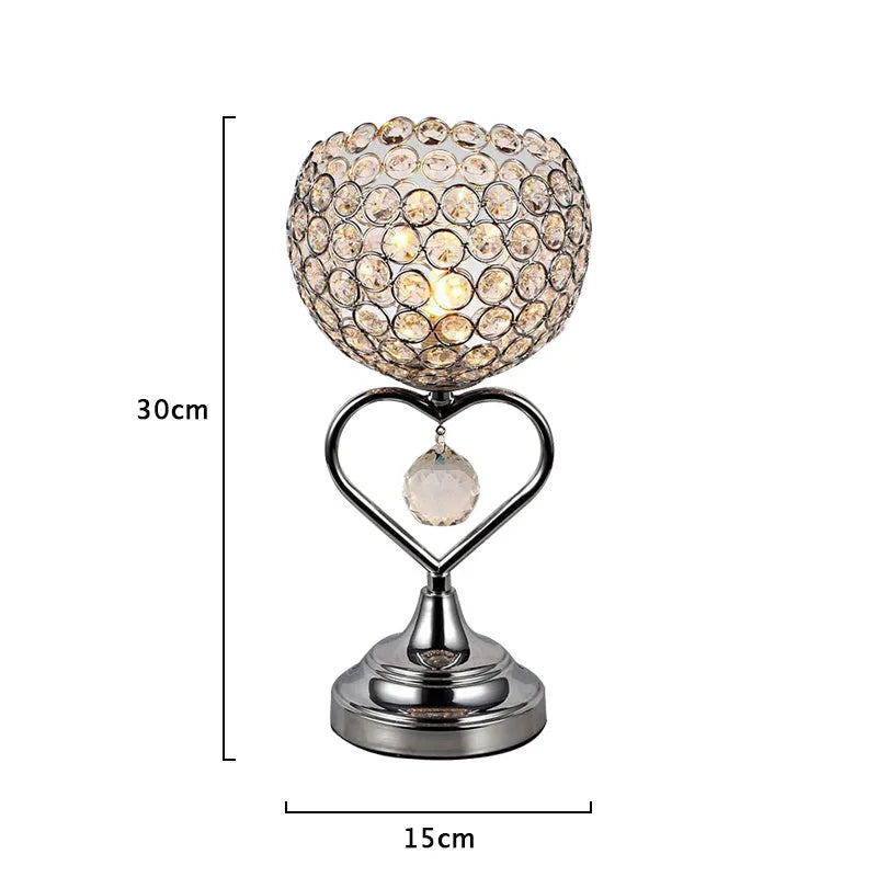 Modern minimalist crystal USB table lamp with heart-shaped design on a bedside table