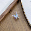 Close-up of an adjustable copper ring with an insect design and a textured dripping oil finish.
