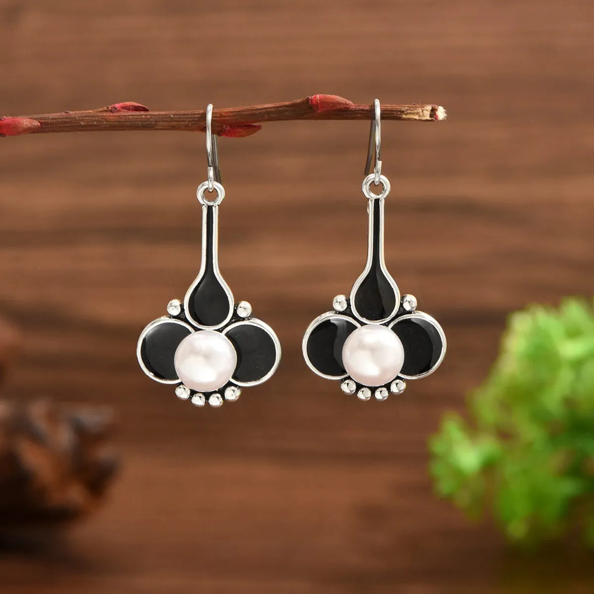 A pair of silver-colour retro fashion drop earrings for women with an electroplated finish.