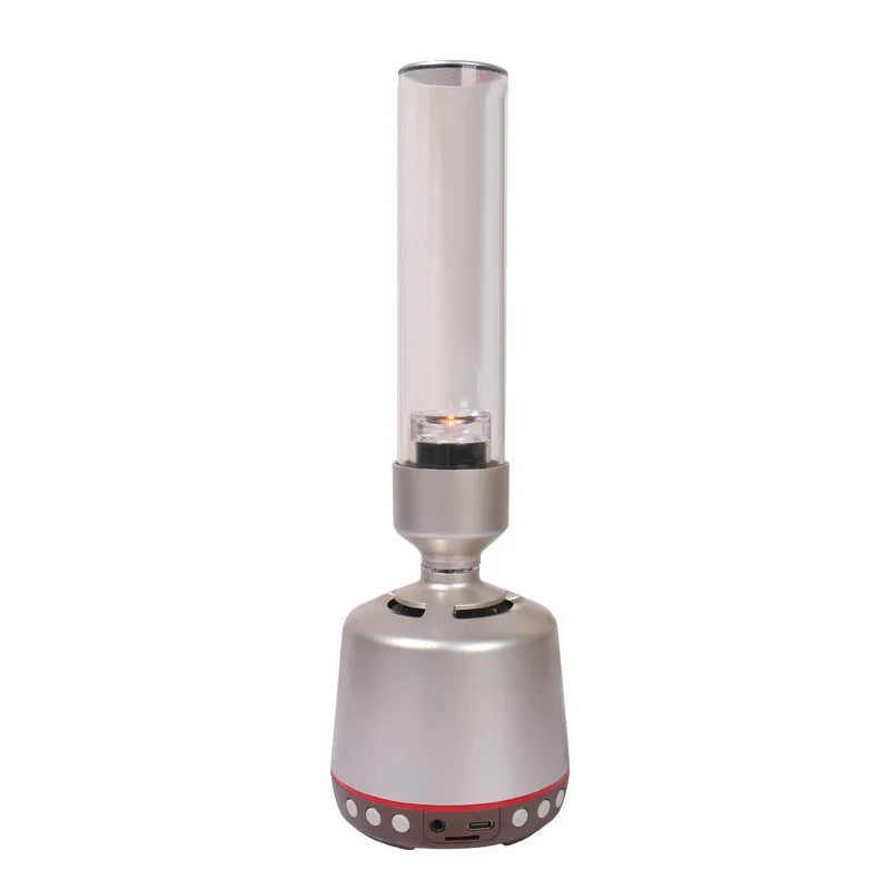 White silver cylindrical Candlelight Bluetooth Speaker Night Light showing warm internal glow and push-button controls.
