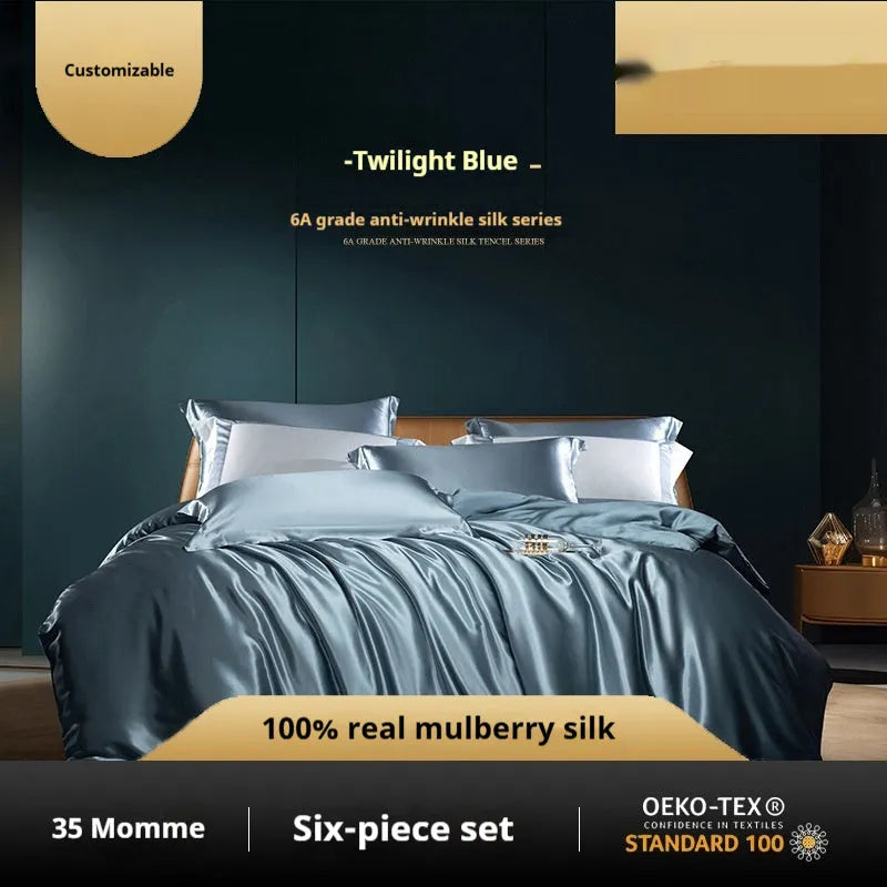 Silk four-piece bedding set in a solid colour displayed on a bed, showing quilt cover and pillowcases.