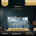 Silk four-piece bedding set in a solid colour displayed on a bed, showing quilt cover and pillowcases.
