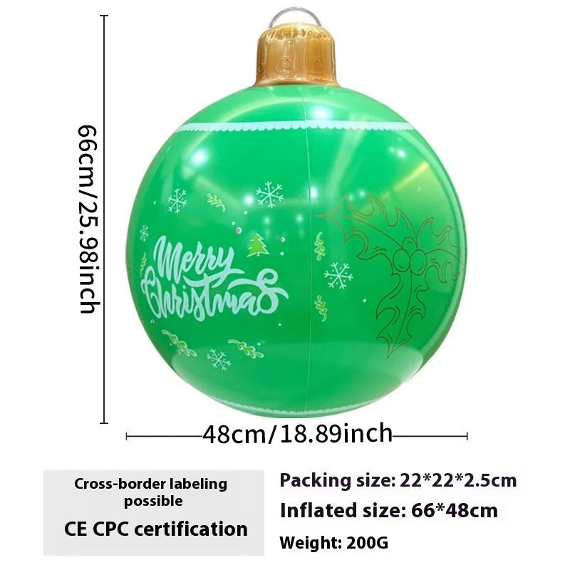 Large red and white inflatable Christmas ball with flashing lights standing in a garden.