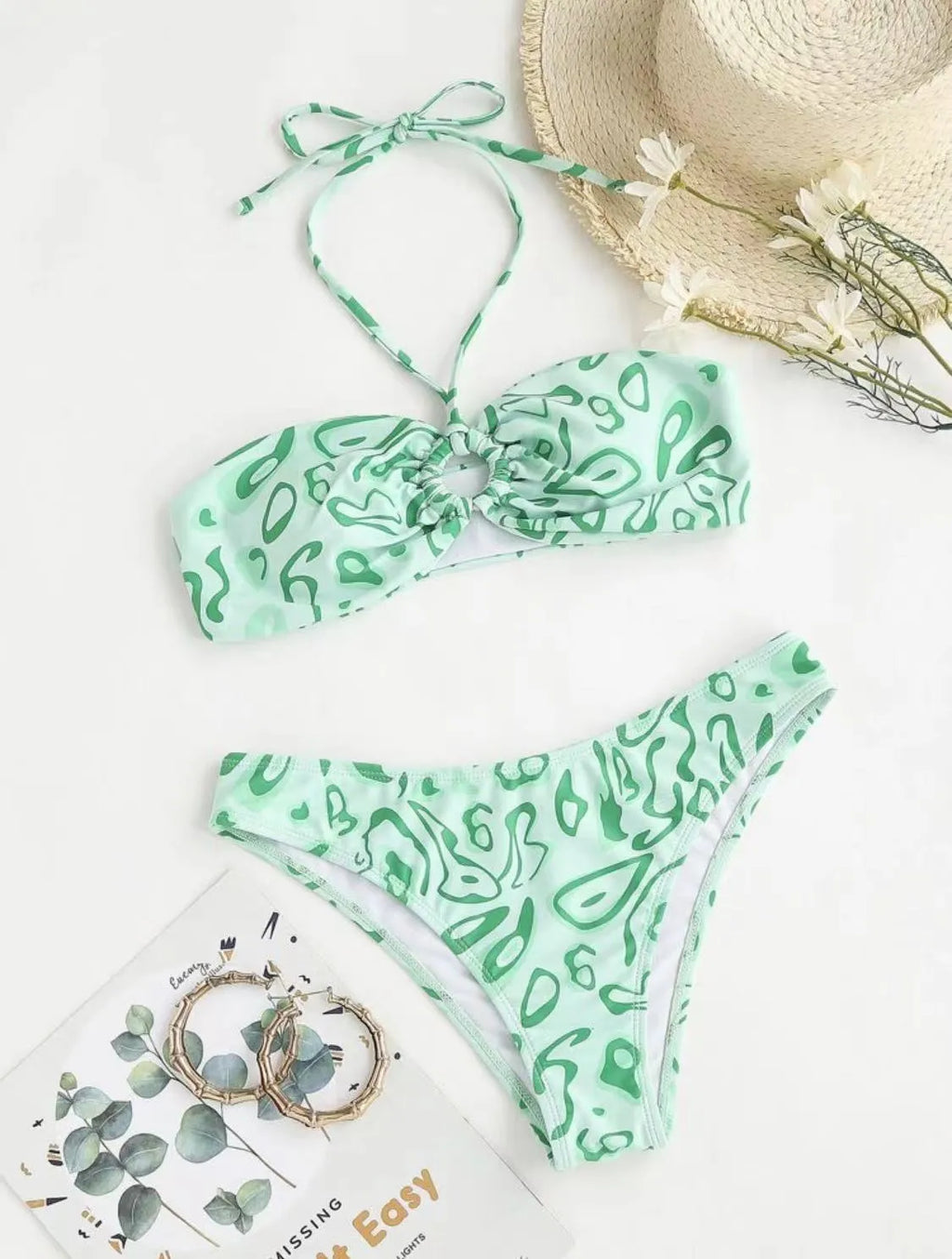 Green floral bandeau bikini swimsuit with split design and adjustable straps on mannequin