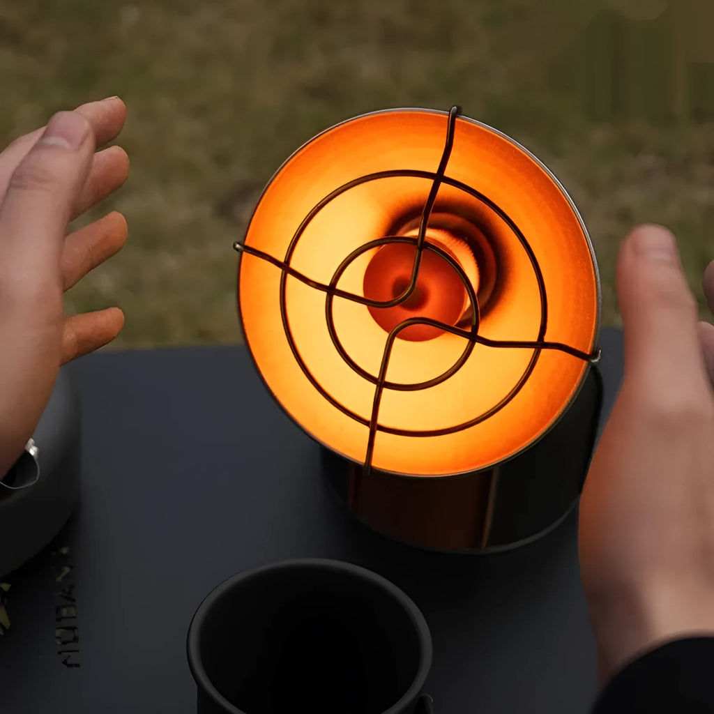 Black and orange portable outdoor heating stove with automatic ignition for camping.