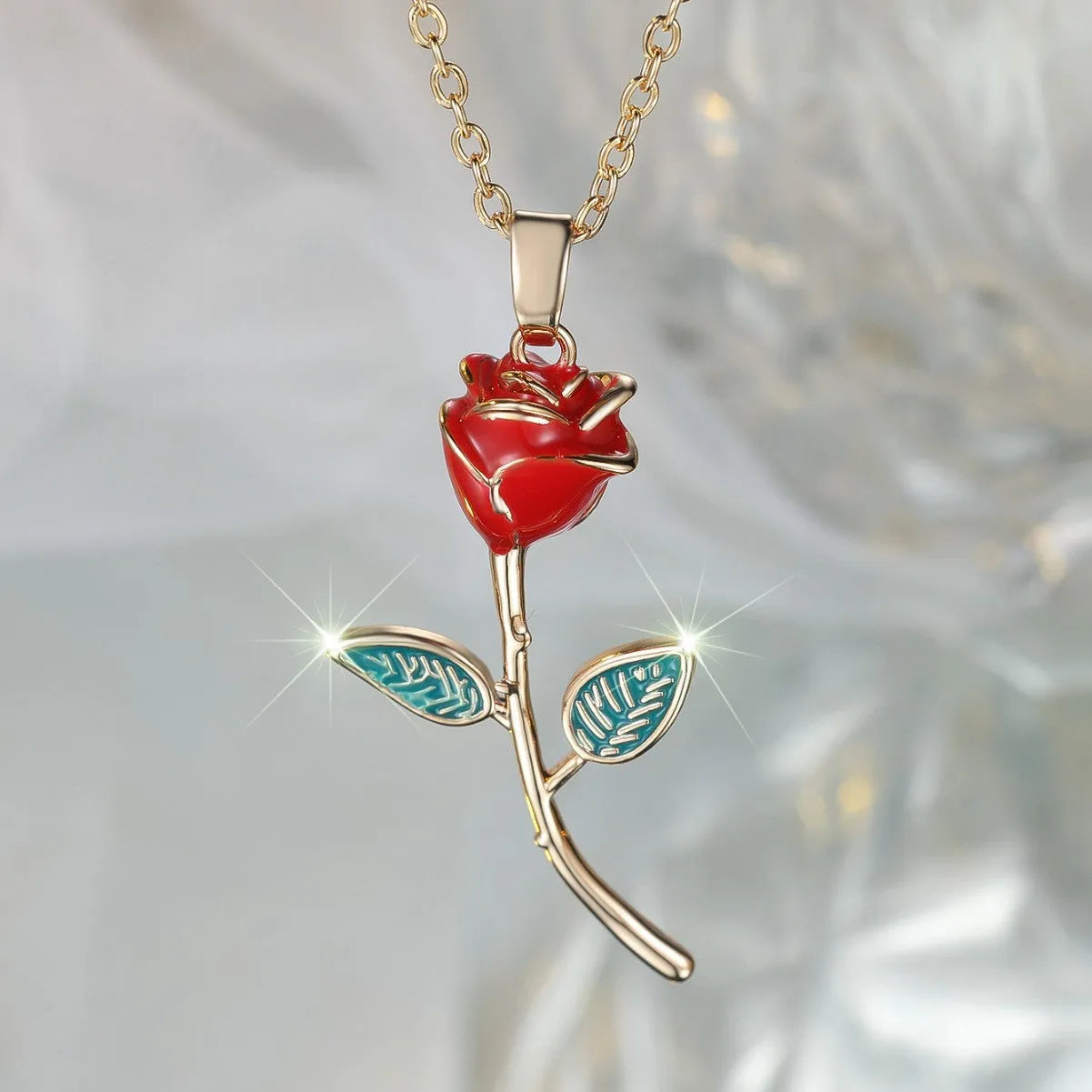 Champagne gold rose pendant necklace with copper drip oil finish and O-ring chain on display