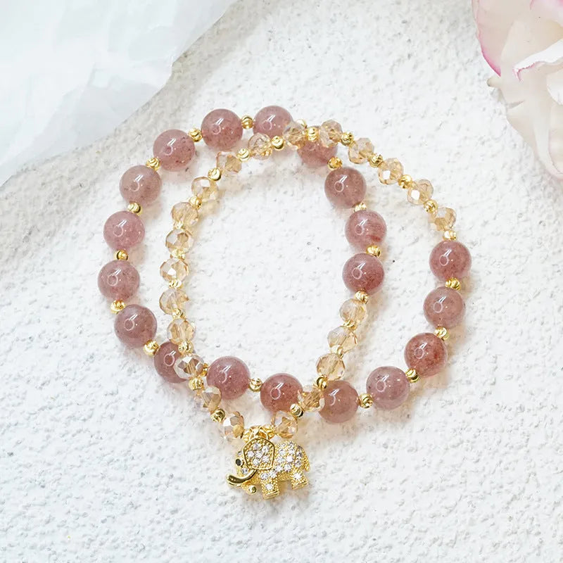 Retro style women's bracelet with colour hair crystal or strawberry quartz beads on a wrist.