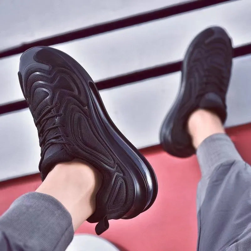 Men's black air cushion running sneakers with white accents and a thick sole on a white background.