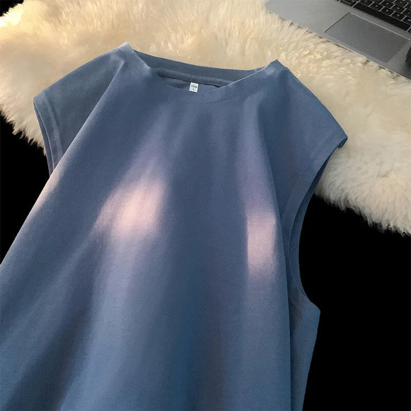 Men's loose fit solid colour cotton tank top shown in a selection of available colours and sizes.