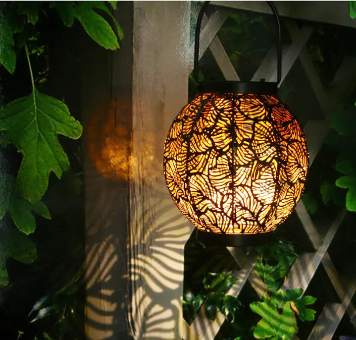 Solar-powered decorative iron courtyard lantern with warm white LED light.