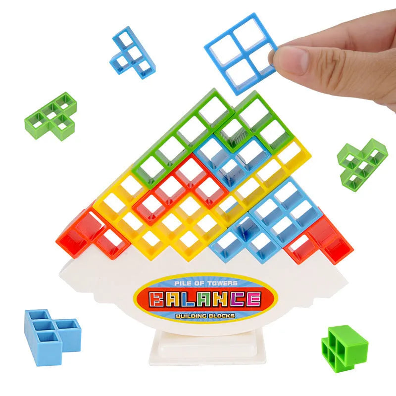 Plastic balance stacking game with coloured blocks on a tilting base, packed in a 26.5 cm box.