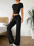 Black high-waisted trousers and short sleeve T-shirt co-ordinated suit for women.