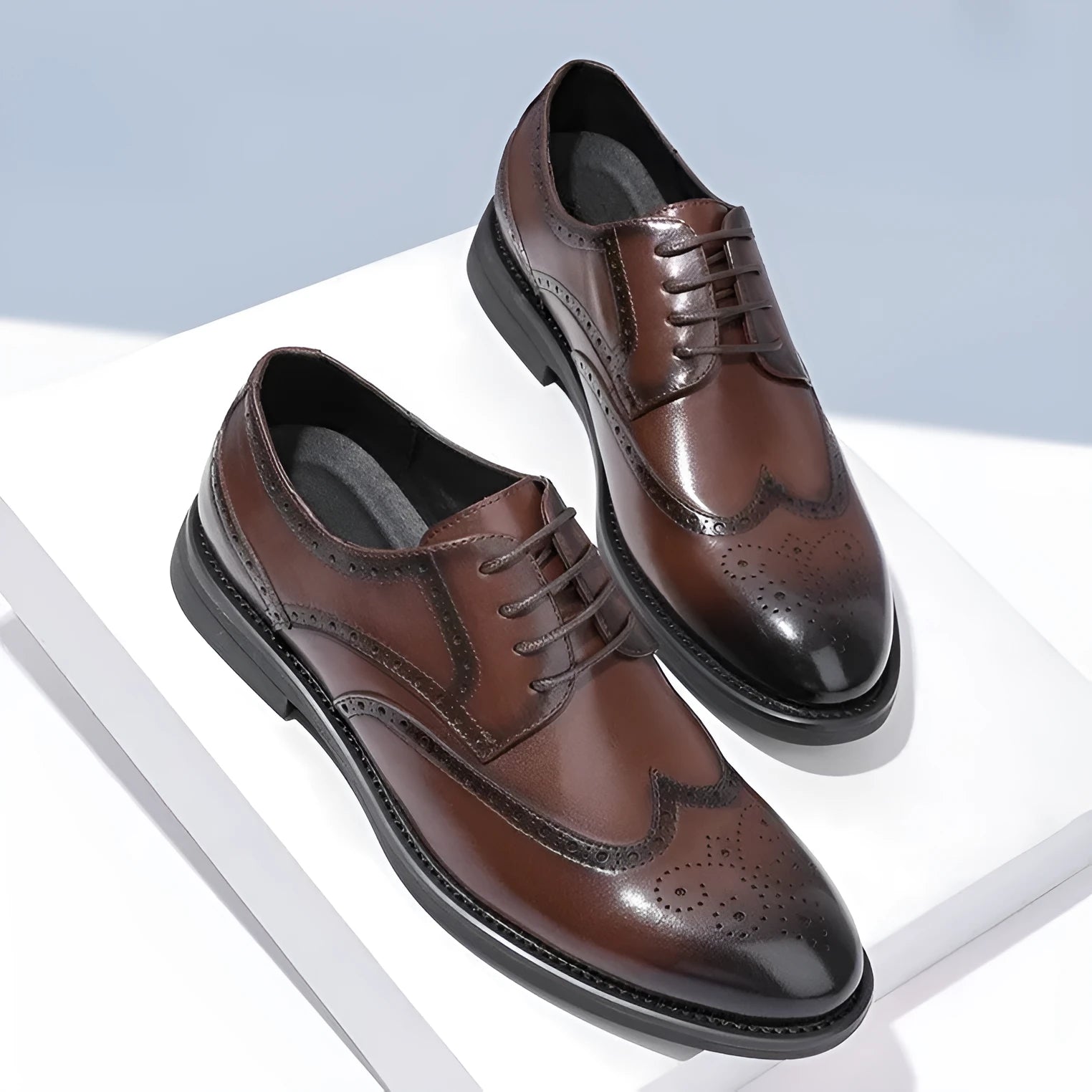 Men's black and brown brogue business shoes with a PU leather upper on a white background.
