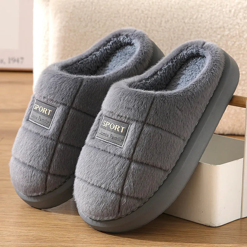 Men's grey and brown plaid winter slippers with a thick wool lining and a textured waterproof sole.