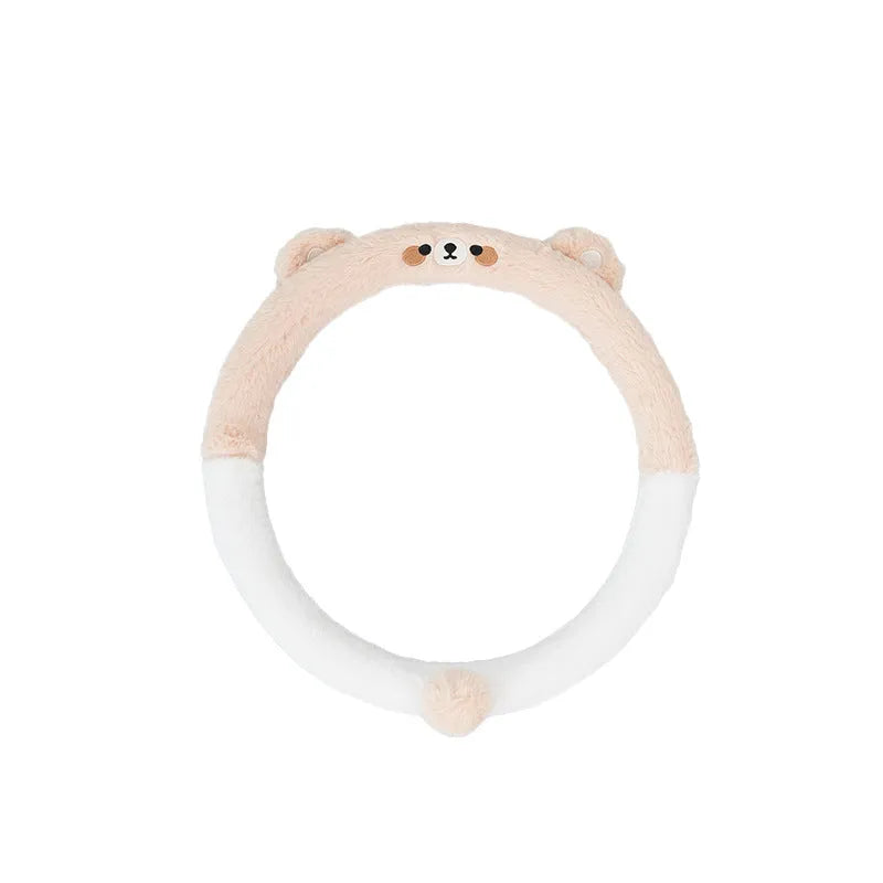 Plush furry steering wheel cover with embroidered panda face, fitted on a car steering wheel.