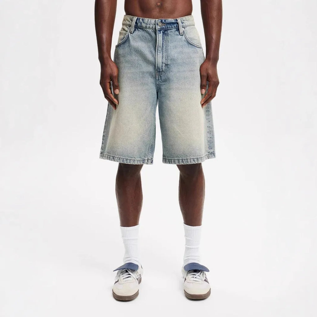 Men's light blue loose straight-leg cotton denim trousers on a mannequin.