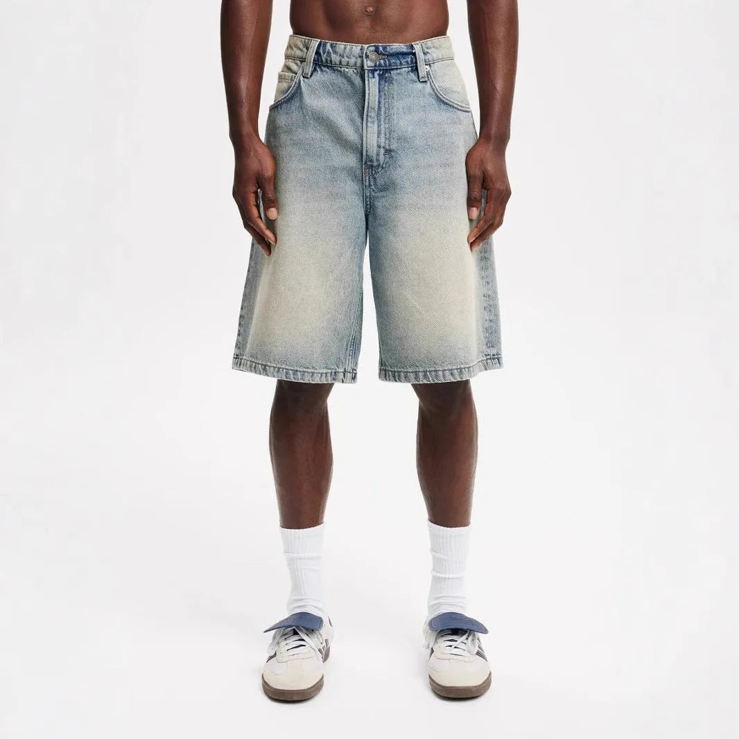 Men's light blue loose straight-leg cotton denim trousers on a mannequin.