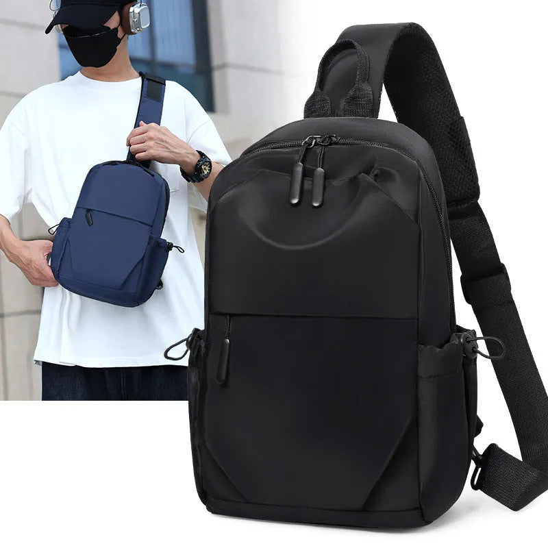 Grey men's chest bag worn across the shoulder, showing main compartment and waterproof-treated fabric.
