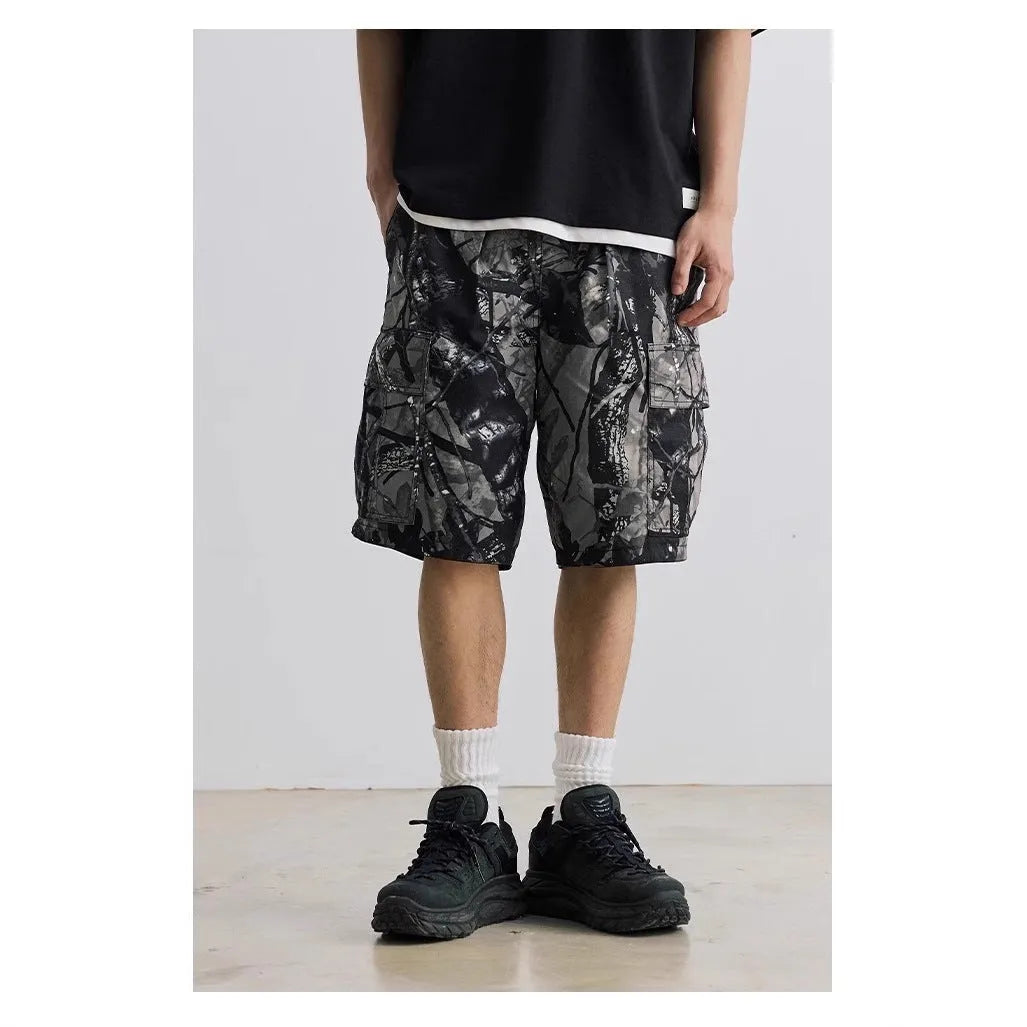 Loose casual straight-leg denim shorts in black on a hanger, showing mid waist and zip fly.