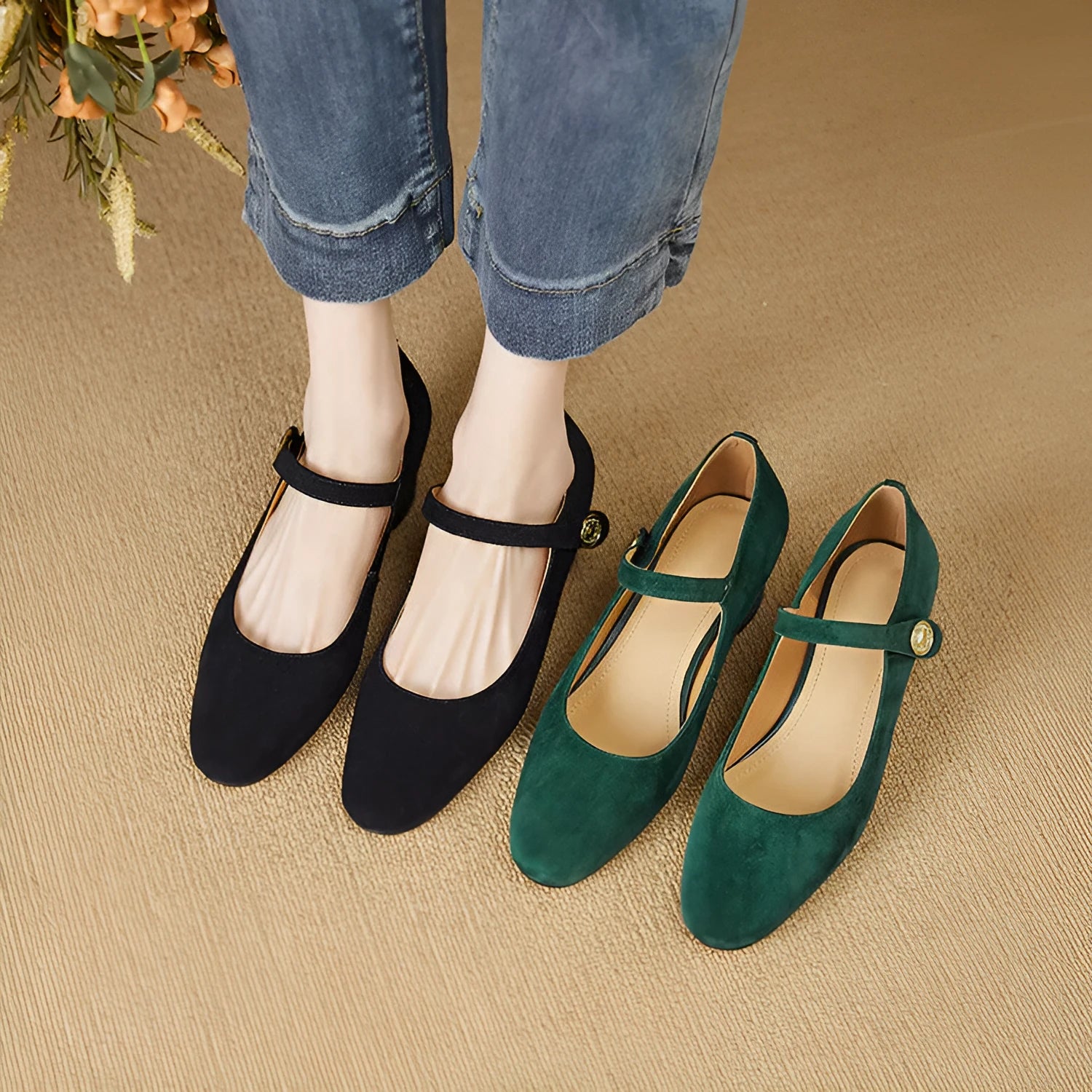 Women's black suede Mary Jane shoes with a square toe and chunky heel on a white background.