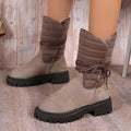 Women's black suede chunky heel snow boots with lace-up design and fleece lining on a neutral background.