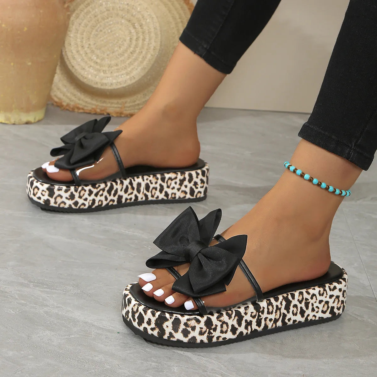 Women's black and white leopard print beach slippers with a thick sole and round toe.
