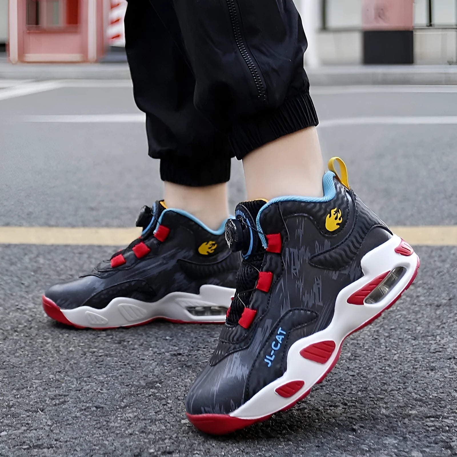 Children's black and coloured rotating button basketball shoes with a PU sole.