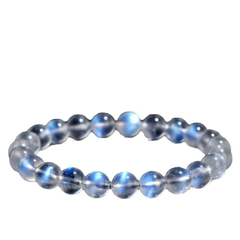Natural cream coloured Blue Moonlight crystal bracelet on a wrist, showing minimalist unisex design.