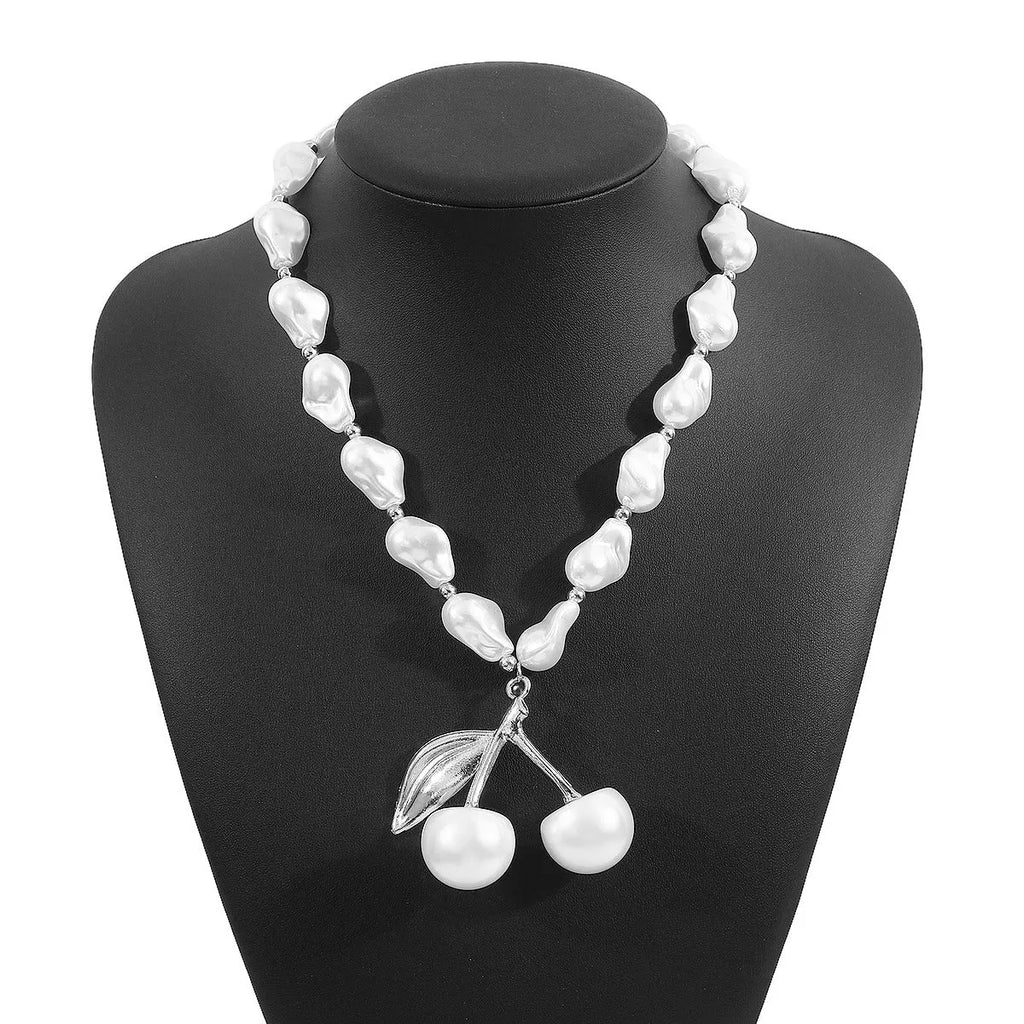 Gold irregular cherry fruit pendant on a white imitation pearl chain necklace, adjustable from 51 to 60 cm.