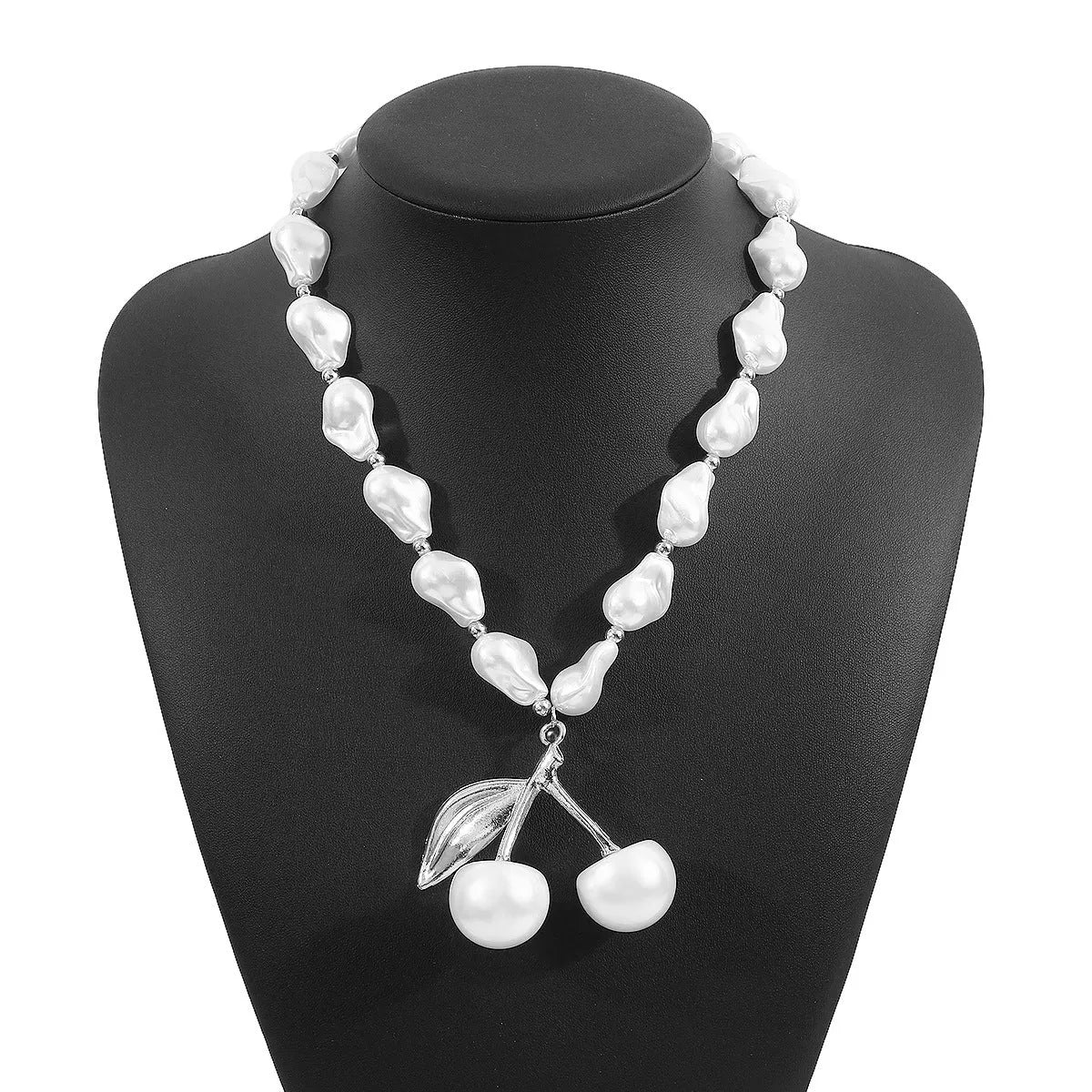 Gold irregular cherry fruit pendant on a white imitation pearl chain necklace, adjustable from 51 to 60 cm.
