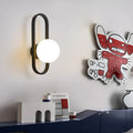 Minimalist wall-mounted lamp with glass shade and iron body in black or gold finish, showing 12W tri-colour LED light.